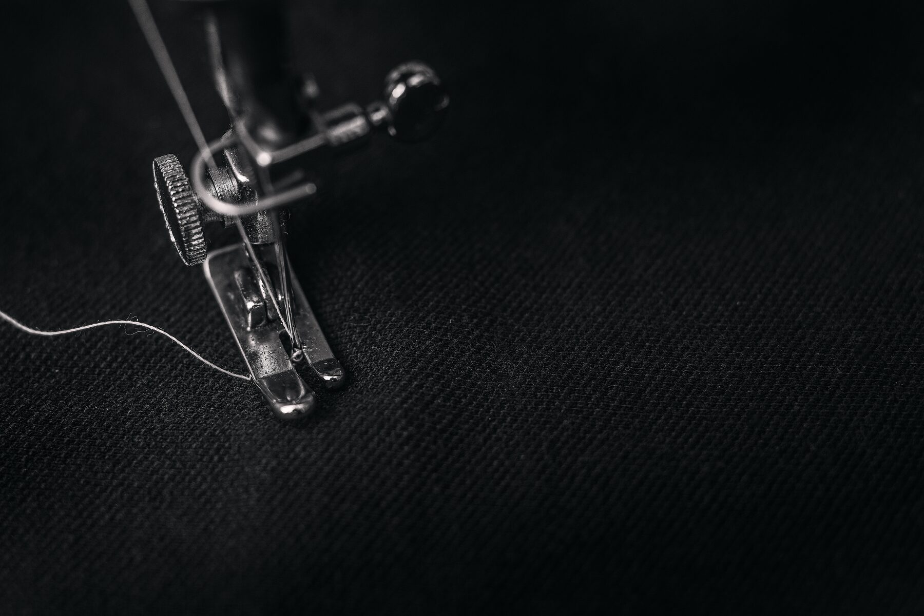 Photo by Alexander Andrews on Unsplash showing hands stitching fabric